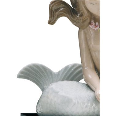 Mermaid figure with arms on...